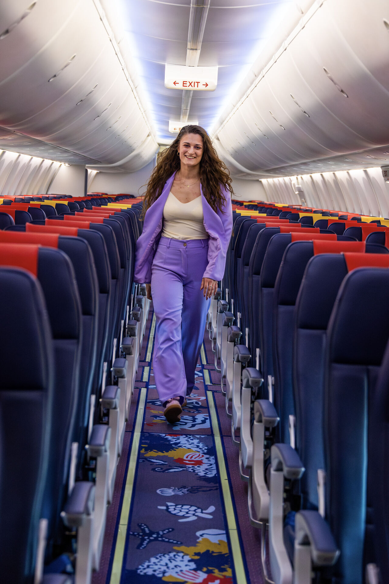 Corendon aircraft cabin with a colorful illustrated aisle carpet