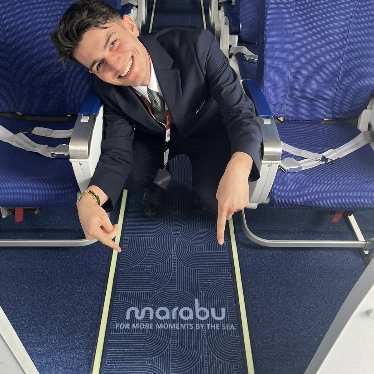 Close view of Marabu branding and linework in a dark blue aisle carpet