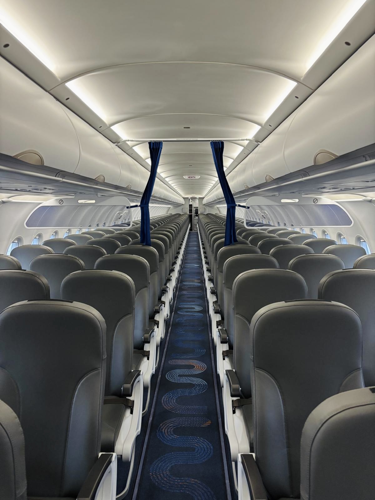 Marabu aircraft cabin with a flowing blue aisle carpet pattern